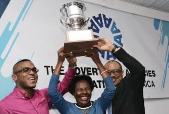 The Gleaner’s Business Development Manager Nordia Craig (centre) and Paul Allen (left), assistant marketing and communications manager of The Jamaica Observer, lift high the Advertising Agencies Association of Jamaica (AAAJ) Top Trophy which they will share. Joining in the celebration is Kingsley Morris, president of the AAAJ