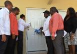 Minister Hon. Noel Arscott & Mayor Everton Fisher cutting the ribbon to signal the opening of the new Sanat Cruz Poor Relief office